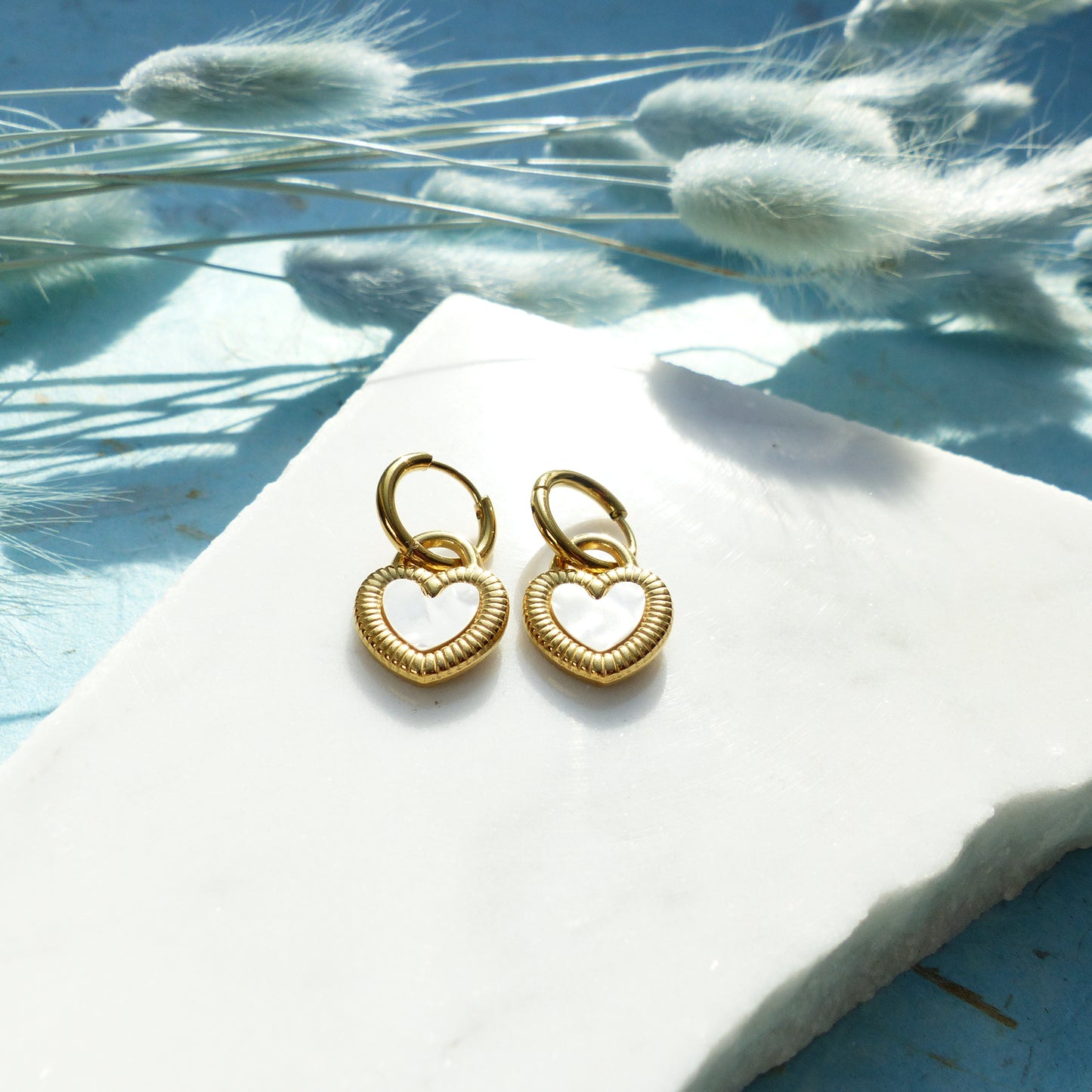 Herzförmige Ohrringe in Gold und Silber mit Wechselseite aus Edelstahl